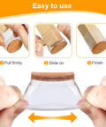 Illustration showing clear Thirty Six Pack Chair Leg Floor Protectors For Hardwood Floors being stretched over round furniture leg.
