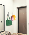 Heavy Duty Stainless Steel Hat Organizer And Hat Rack For Wall Built Tough To Store Your Favorite Baseball Caps Without Breaking A Sweat, mounted with colorful caps and a green bag.