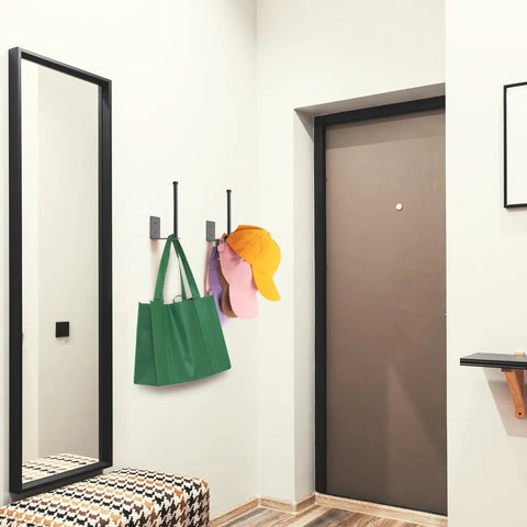 Heavy Duty Stainless Steel Hat Organizer And Hat Rack For Wall Built Tough To Store Your Favorite Baseball Caps Without Breaking A Sweat, mounted with colorful caps and a green bag.