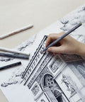 Artist drawing architecture with Conte & Pastel pencils; features precise detailing and blending for sketches and fine art.