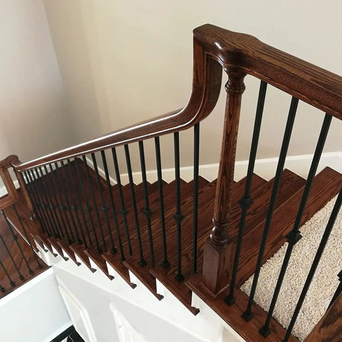 Flat Shoe For Half Inch Square Iron Balusters With Side Set Screw Satin Black Finish 30 Pack For Treads Balconies And Handrails Durable Aluminum Support Ensures Sturdy Railings. Wooden staircase with satin black balusters and flat shoes.