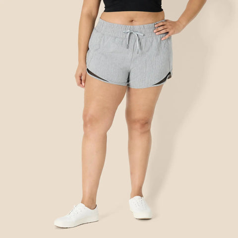 Model wearing Women's Regular Fit Athletic Woven Running Shorts With Ruched Waistband, Gray Heather, Size Medium, front view.