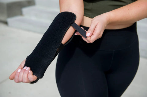 Person demonstrating adjustable fit of Red Light Therapy Wrist Wrap For Pain Relief And Carpal Tunnel Support on arm.