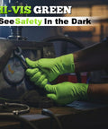Pair of bright green nitrile gloves with textured grip gripping a wrench in an industrial workshop.