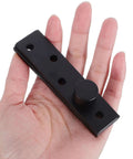 Person holding Hidden Door Pivot Hinge Full Rotation For Wood Doors Beefy Heavy Duty Metal Construction Matte Black Concealed Invisible.