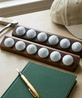 Two Pack Walnut Golf Ball Holder Display Case With Wall Mount Or Tabletop Stand For 12 Standard Balls on a desk