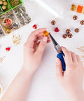 Person using pliers from 1500 Piece Silver Jump Ring Set With Lobster Clasps And Jewelry Pliers For DIY Jewelry Making Supplies Findings And Necklace Repair Beading Kit For Crafters.