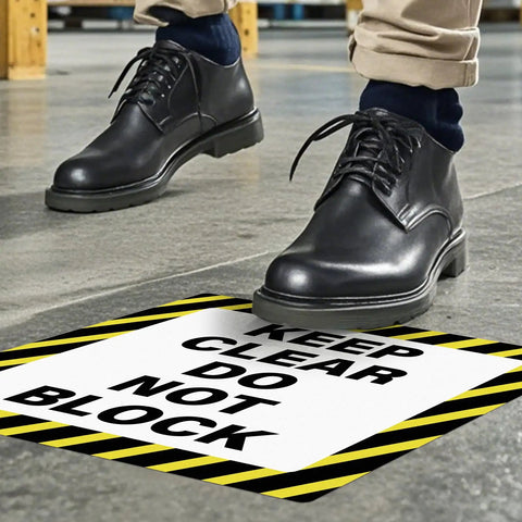 Person walking near a Keep Clear Do Not Block Sign 17 By 17 Inches 5 Pack Self Adhesive Waterproof Vinyl Safety Stickers For Factory Warehouse And Workplace Caution Warning Signage