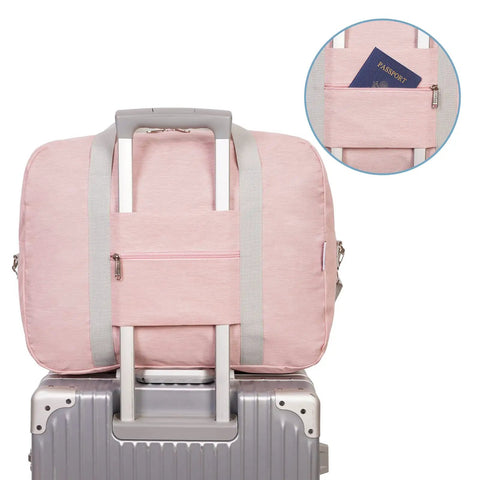 Back view of 30L Foldable Personal Item Duffel Bag 18x14x8 Inches Pink With Shoulder Strap, attached to luggage handle, pocket detail