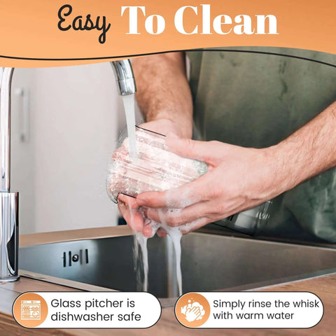 Washing glass pitcher of Milk Frother With Glass Pitcher Handheld Battery Operated Foam Maker for easy cleaning at a sink.