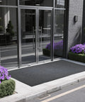 Heavy Duty Indoor Outdoor Entrance Mat 4 By 10 Feet Rubber Border Door Rug with non-slip tread at an entrance with flowers.