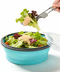 Collapsible Silicone Camping Bowl With Airtight Lid 1200ml Foldable Travel RV Leakproof Food Storage Microwave And Fridge Safe Includes Stainless Steel Fork Road Trip Ready with salad and dressing in blue bowl