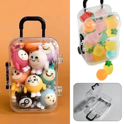 Front view of a clear plastic mini luggage storage box with black handle and side latches, filled with plush toys.