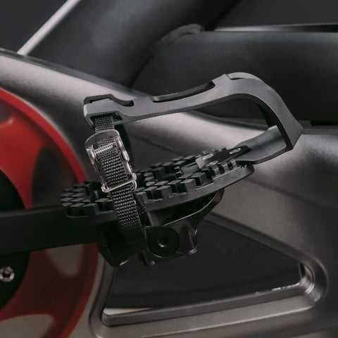 Close-up of Toe Clip Cage Adapters for Look Delta Pedals on spin bike, showcasing pedal conversion for sneakers.