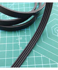 PJ307 Drive Belt For Conveyor Systems High Elasticity Timing Belt With Safety Shield Reduces Vibration, Delivers Smooth, Quiet Operation And Rock Solid Positioning For Reliable Transport. Black 4-rib conveyor timing belt on cutting mat