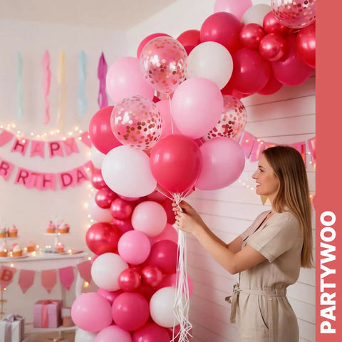 Woman arranging 66 Piece 12 Inch Hot Pink And Red Balloons Set With White And Gold Confetti For Valentines Day Decor