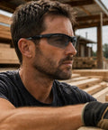Hardcore Photochromic Safety Glasses With Slick Adaptive Lenses And Uv400 Shield For Serious Eye Protection During Cycling Diy Tasks And Outdoor Jobs Built Damn Tough For All Day Wear In Storm Gray Blue on a man working in a woodshop.