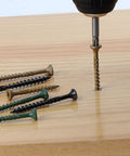 Built Tough Heavy Duty Deck Screws Black Carbon Steel With Torx Drive being installed into wood with assorted screws around.