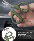 Decked-Out Fishing Tools Kit With 6.5 Inch Pliers And 4.6 Inch Scissors, Pro Grade Stainless Steel Line Cutter For Braided Line, Lanyard Included, Great For Kayak, Fly, And Freshwater Fishing; close-up of green handle scissors in hand with fisherman background