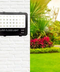 JUDYSSY Solar Flood Lights Led Flood Light on a wall, showcasing 30W 3000Lm, IP65 waterproof design for outdoor use.