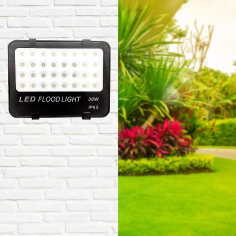 JUDYSSY Solar Flood Lights Led Flood Light on a wall, showcasing 30W 3000Lm, IP65 waterproof design for outdoor use.