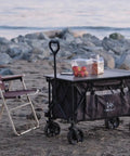 Folding Collapsible Utility Wagon For Outdoor Hauling With Table Top And Side Pocket 400Lbs Heavy Duty Cart on a beach