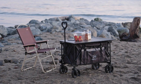 Folding Collapsible Utility Wagon For Outdoor Hauling With Table Top And Side Pocket 400Lbs Heavy Duty Cart on a beach