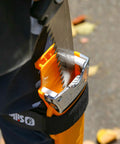 Inserting Heavy Duty Pro Saw With 330mm Blade And XL Teeth, 6.5 Inch Cut Capacity, into sheath for tough woodworking and outdoor cuts.
