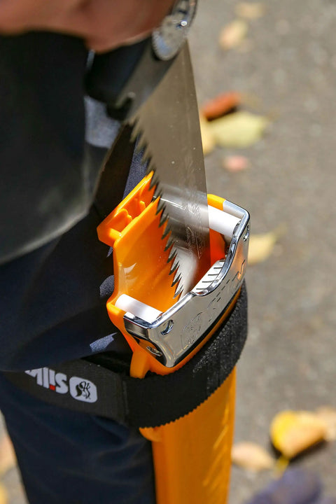 Inserting Heavy Duty Pro Saw With 330mm Blade And XL Teeth, 6.5 Inch Cut Capacity, into sheath for tough woodworking and outdoor cuts.