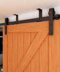 Ceiling Mount Sliding Barn Door Hardware Kit For Low Ceiling Spaces With L Shape Bracket System Fits 36 Inch Wide Single Wood Doors Heavy Duty Carbon Steel Hangers Supports Up To 220 Lb Per Door, shown installed on wood door.