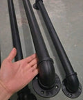 Badass Industrial Wrought Iron Stair Railing Kit Twenty Foot Wall Mount Banister Pipe Rail showing curved black pipe fittings.