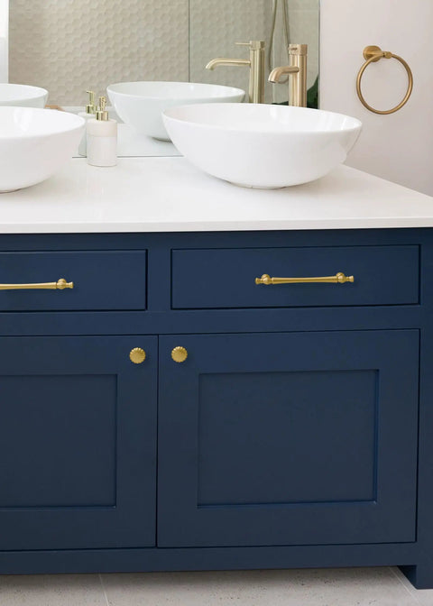 Top Tier Brushed Gold Cabinet Pulls With Five Inch Mounting Centers And Solid Metal Build For Kitchens And Baths featuring modern design on navy cabinet.