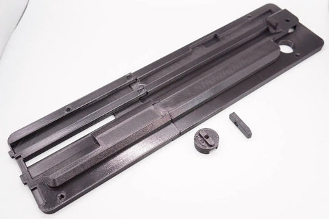 Throat Plate Insert With Zero Clearance For Skil TS6307 Table Saw Delivers Cleaner Cuts And Reduced Tearout With Precise Fit Fast No Sweat Install Using Included Cap And Fasteners And Durable Heat Treated Construction. Image of zero-clearance insert with cap and fasteners.