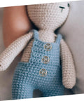 Close-up of doll wearing overalls with 120Pcs Tiny Round Snap Fasteners from Mini Colored Button Set for Doll Clothes and DIY Sewing Projects.