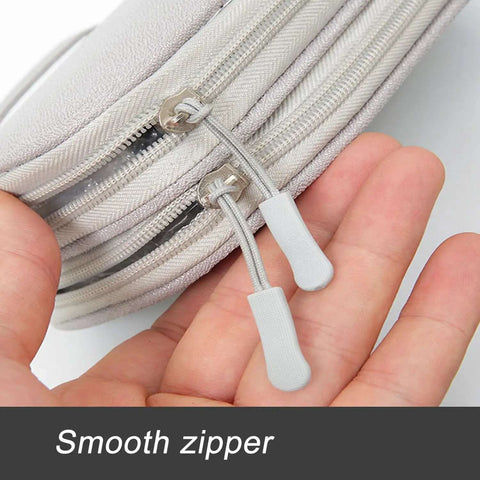 Close-up of smooth zipper on portable double layer electronic organizer travel case, showcasing quality for chargers and gadgets.