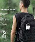 Rechargeable Camping Lantern With Dimmable 2700K To 6500K Light Red Night Light on backpack in outdoor setting