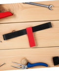 Red Scuba Tank Holder Strap Oxygen Cylinder Carrier for Diving and Snorkeling on a workbench with tools.
