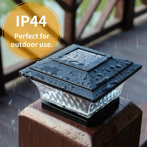 Solar Post Cap Lights For 4x4 Wooden Posts Outdoor LED Deck And Fence Cap Light With Dual Modes Warm White Or Bright White Self-Contained No Wiring Weatherproof Black Eight Pack on post with rain, showcasing IP44 waterproof feature.