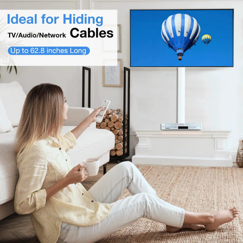 Woman using remote with TV and 62.8 Inch Cable Hider Kit For Wall Mount TV Cables, 4 Pack Cord Covers installed on wall, living room setting