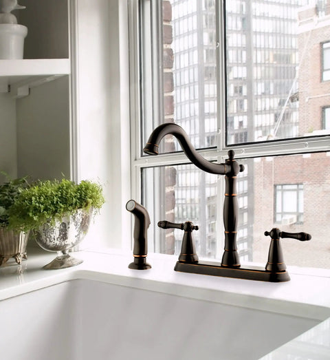 Oakmont Two Handle Kitchen Faucet With Side Sprayer In Oil Rubbed Bronze, Classic Victorian Style, on a kitchen sink
