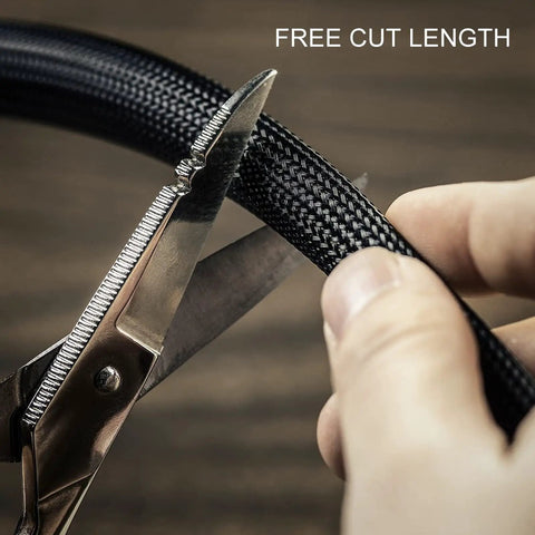Cutting 5mm black self wrapping wire loom with scissors for custom length, ideal for RV, boat, and auto projects.