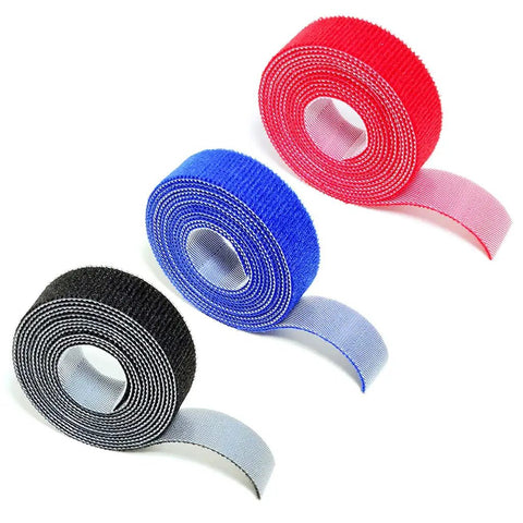 Self Adhesive Cable Management Hoop With Sticky Wire Organizer Keeps Your Desk Slick And Tidy Game Changer Tear Off Nylon Cord Wrap Kit For Home Office In Black. Roll of black, red, and blue nylon cord wraps.