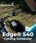 Cyclist using Garmin Edge 540 GPS Cycling Computer With Button Controls, shown mounted on handlebars during outdoor ride