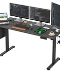 Solid Electric Adjustable Standing Desk With 40x24 Inch Tabletop, Folding Corner Office Table, Dope Gaming Setup, Easy Peasy Study Bedroom Vibes, Portable Walnut Metal Frame, Total Game Changer For Your Daily Grind with dual monitors and laptop.
