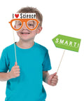 Child holding "I Love Science" glasses and "Smart!" sign from 12 Piece Science Photo Booth Props With Sticks Mad Scientist Selfie Cards
