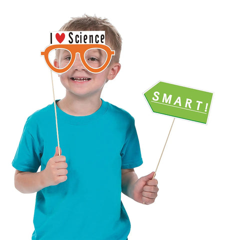 Child holding "I Love Science" glasses and "Smart!" sign from 12 Piece Science Photo Booth Props With Sticks Mad Scientist Selfie Cards
