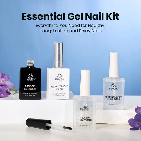 4-Piece Gel Nail Kit With Base Coat, Top Coat, Dehydrator And Primer arranged with flowers, 15ml bottles, on blue background