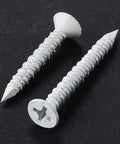 30 Pack 1/4 X 1-3/4 Inch White Flat Head Concrete Screws Professional Carbon Steel Masonry Anchors For Brick Block Stucco Walls Rated Tough For Any Daily Grind close-up of two screws