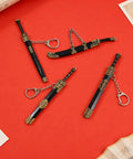Ancient Sword Letter Opener Set With Sheaths 4 Piece Mini Sword Keychain Desk Decor in black and gold on red background.