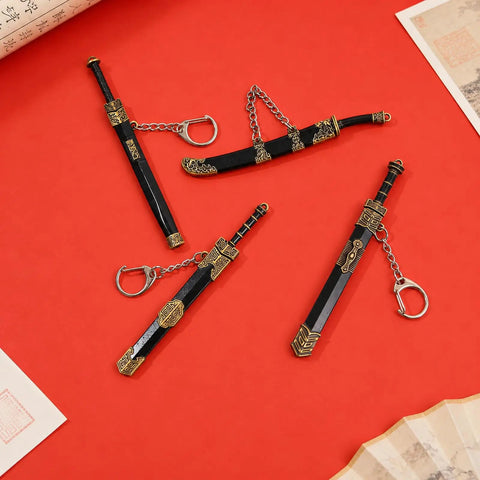 Ancient Sword Letter Opener Set With Sheaths 4 Piece Mini Sword Keychain Desk Decor in black and gold on red background.